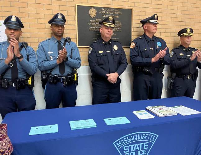 Massachusetts State Police showcase their new blue envelopes, designed to improve interactions with drivers on the autism spectrum, during an event hosted by Advocates for Autism of Massachusetts on Tuesday.