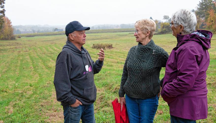 Ed Hamel, co-owner of Glendale Ridge Vineyard with his wife, Mary, at right, talk with Cindy Palmer, chair of the Southampton Open Space Committee. They are standing on a portion of the 80 acres the Hamels are placing in a conservation restriction.