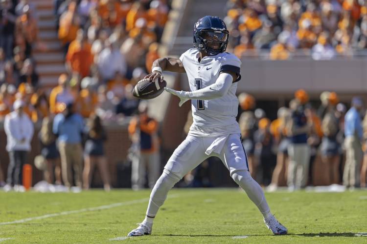 UConn quarterback Ta'Quan Roberson (1) throws to a receiver during the first half against Tennessee earlier this month in Knoxville, Tenn.