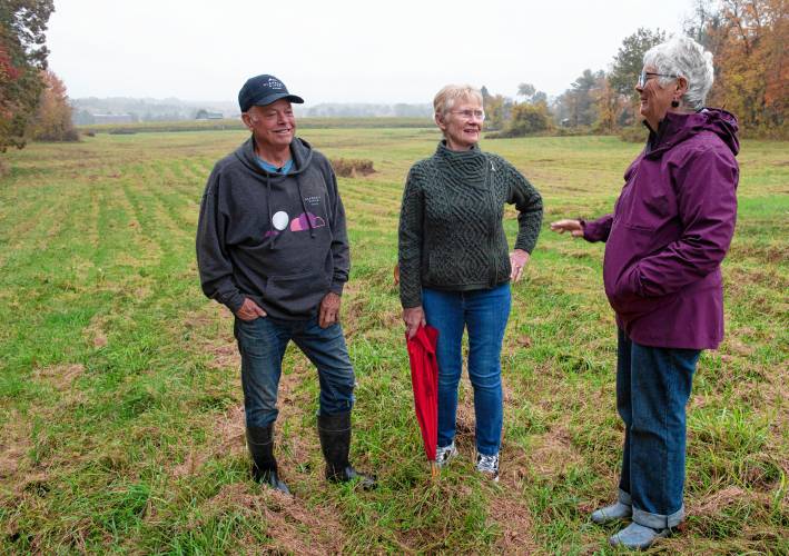 Ed Hamel, co-owner of Glendale Ridge Vineyard with his wife, Mary, at right, talk with Cindy Palmer, chair of the Southampton Open Space Committee. They are standing on a portion of the 80 acres the Hamel’s are placing in a conservation restriction.