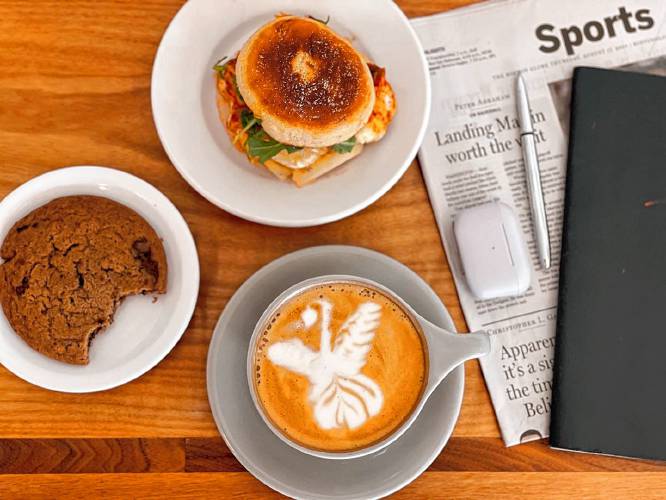 A breakfast sandwich chock full of local ingredients pairs well with a cappuccino at Share Coffee Roasters cafe.
