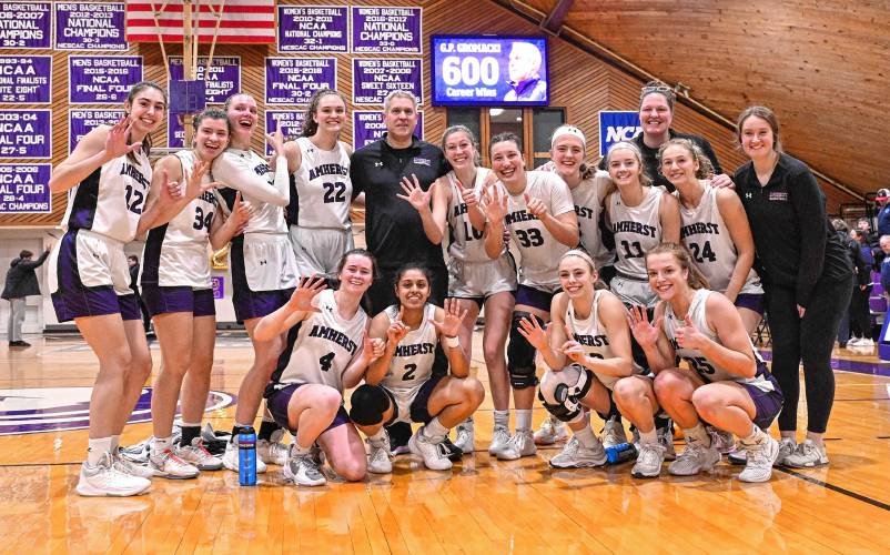 Amherst College women’s basketball coach G.P. Gromacki poses with his team following last week’s win over Connecticut College at LeFrak Gymnasium in Amherst. The victory was No. 600 for Gromacki, who became the fastest coach in NCAA history to reach that mark.