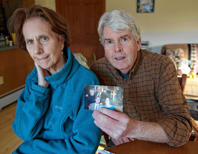 Jan Ryan and Jack Horrigan with a photograph of Jack’s parents, Peg and Jack Horrigan, whom the couple made a toy fund donation in memory of this year.