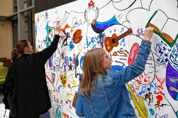 Margot LaBarge, 13, right, and Elizabeth Sukhovskaya add their creations to a collaborative mural commemorating Smith Arts Day on Saturday in the atrium of the Smith College Museum of Art in Northampton. Presented by the Smith Office for the Arts, the daylong celebration of the artistic and creative community at Smith College included a variety of performances, exhibitions, workshops, and art-making activities across campus.