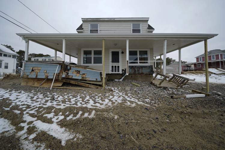A roof is temporarily stabilized, Wednesday, Jan. 31, 2024, in the Camp Ellis neighborhood of Saco, Maine. A powerful coastal storm washed away most of the home’s wrap-around porch.