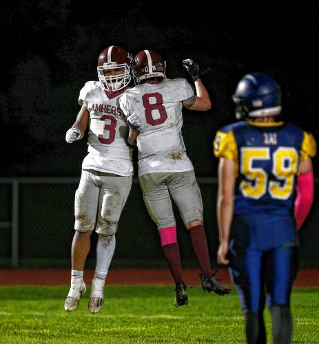 Amherst’s Junior Ramsey (3) celebrates with Matthew Hockman (8) after scoring a touchdown against Northampton earlier this season in Northampton.