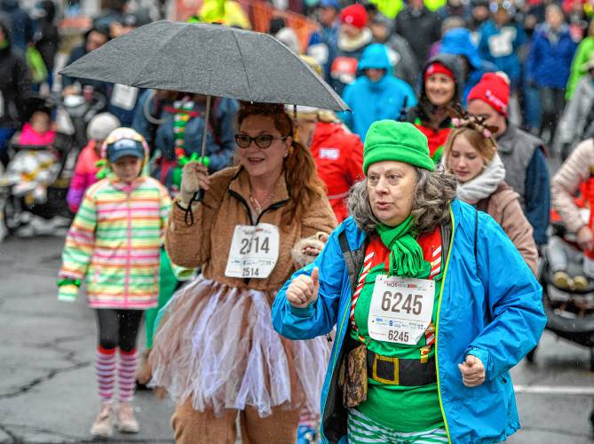 Three kilometer walk participants Janet Bryant, left, of Ware, and Tina Thompson-Sullivan of South Hadley start their event the 20th annual Hot Chocolate Run on Sunday to raise money for Safe Passage’s mission to provide support and services to survivors of domestic violence.