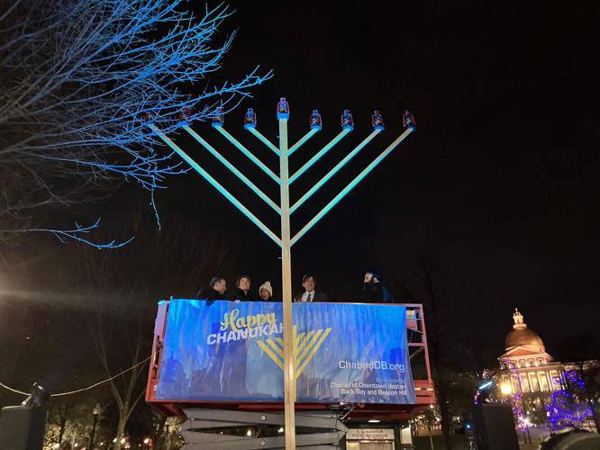 Gov. Maura Healey and Boston Mayor Michelle Wu joined Jewish leaders in ascending the 22-foot menorah on the first night of Hanukkah on Thursday. 