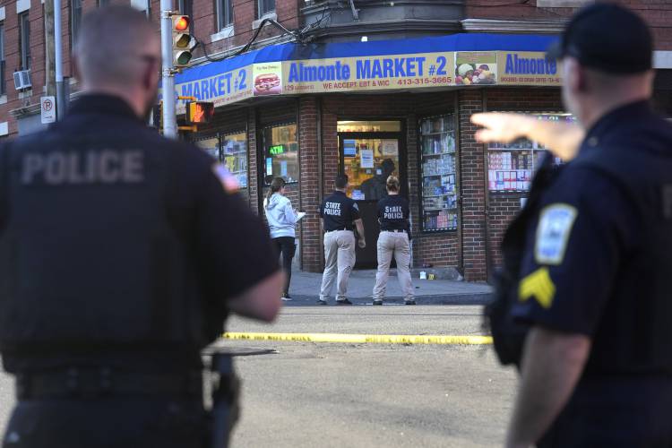 Law enforcement officials investigate the scene where multiple were shot, Oct. 4, in Holyoke. 