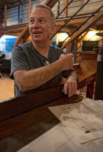 Randy Krotowski, president of the board of the Parlor Room, talks about the Iron Horse Music Hall and its future renovations while looking over plans in the club on Wednesday morning. 