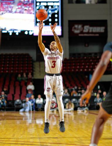 UMass guard Rahsool Diggins (3) hits a three-pointer against South Florida earlier this season at the Mullins Center in Amherst.