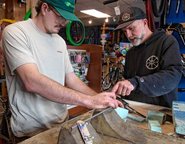 Daniel Fitzgibbons and Jason Graves, owner of Full Circle Bike Shop, work on adding a set of stairs and rail to the Fingerboard Park after the famous spot at UMass where many skaters have been filmed and photographed skating.