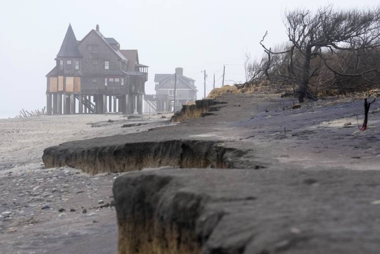 Houses resting on pylons are elevated above the beach, Thursday, Jan. 25, 2024, in South Kingstown, R.I. Experts say erosion and receding shorelines are becoming more common due to ocean rise and climate change.
