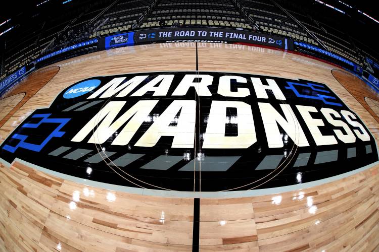 This is the NCAA March Madness logo at center court before a practice day for NCAA college men’s basketball teams participating in the first and second round tournament games at PPG Paints Arena in Pittsburgh, Wednesday, March 20, 2024.