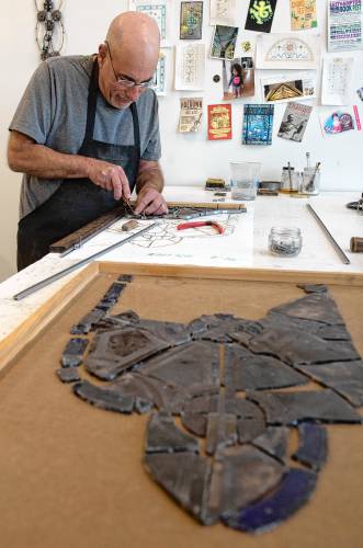 Glenn Shalan, owner of Shalan Stained Glass in Easthampton, works in his studio, where he is restoring windows from Riverside Church in New York City.
