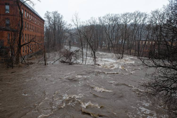 The Mill River flowing under the  bridge on Mulberry Street in Leeds during the flooding and rain on Monday. 