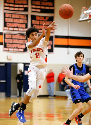 South Hadley’s Isiah James (11) dishes a pass against Granby in the fourth quarter Wednesday night in South Hadley.