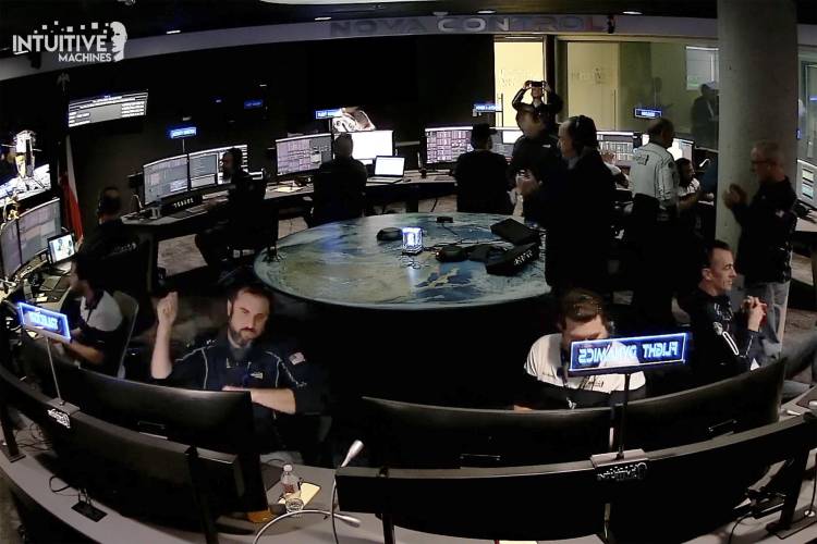 An image taken from video released by Intuitive Machines shows flight controllers at Intuitive Machines in Houston react after its private spacecraft touched down on the moon on Thursday, Feb. 22, 2024. The craft sent back a weak signal and there were no immediate updates on the lander's condition. (Intuitive Machines via AP)