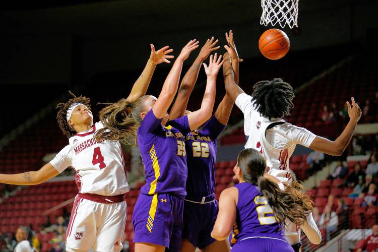 UMass center Chinenye Odenigbo (2), right, and guard Lilly Ferguson (4) fight for a rebound against UAlbany defenders Deja Evans (22) and Meghan Huerter (23) in the third quarter Wednesday at the Mullins Center in Amherst.