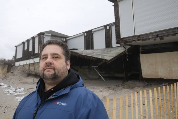 Conrad Ferla, founder of Protecting Coastal Access, stands for a photograph in front of a damaged structure on Dunes Club Beach, Thursday, Jan. 25, 2024, in Narragansett, R.I. Experts say erosion and receding shorelines are becoming more common due to ocean rise and climate change.