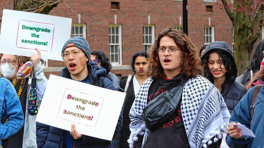 Nicolás Cardona, right, a member of the UMass Students for Justice in Palestine, joins other protestors at a rally held Thursday in front of the school’s Whitmore Administration Building, to demand an end to probations for students arrested at a sit-in protest against the war in Gaza in October. 