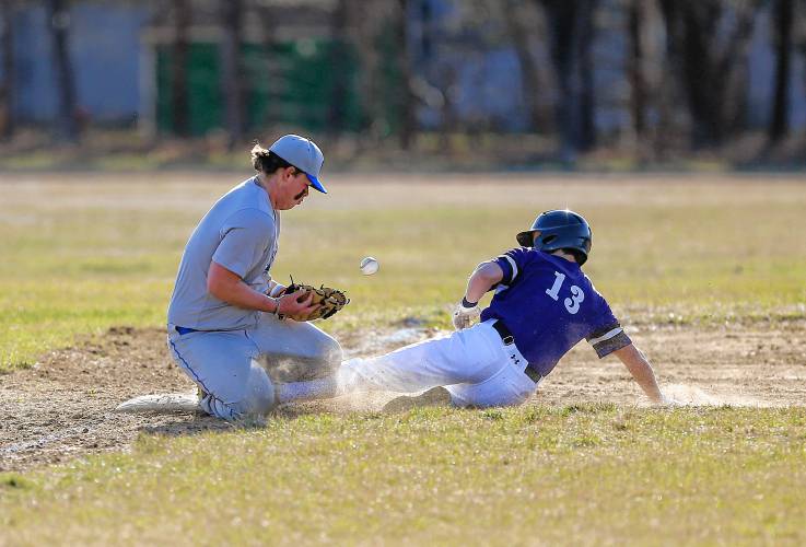 Smith Academy baserunner Cam Graves (13) slides safely into third base ahead of the tag from Granby third baseman Spencer Labonte (11) in the top of the third inning Friday in Granby.