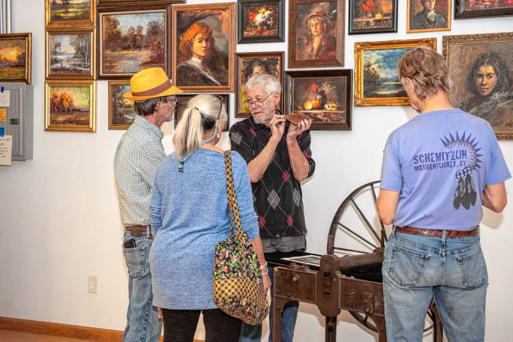 Painter D.F. Wilhem, third from left, talks to visitors to his studio at last year’s Open Studios weekend at Eastworks.