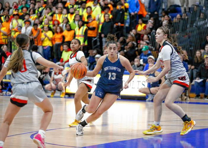 Northampton’s Ava Azzaro (13), middle, drives the ball between Worcester South defenders Lydia Charlonne (0) and Madi Leighton (13) in the third quarter of the MIAA Div. 2 girls basketball state semifinals last week at Chicopee Comp High School.