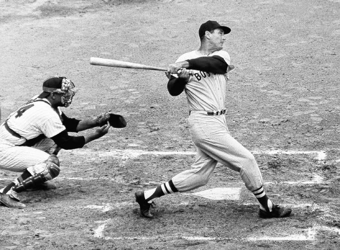 Ted Williams of the Boston Red Sox knocks the ball out of the park for a home run in the second inning against the Washington Senators on  April 18, 1960.