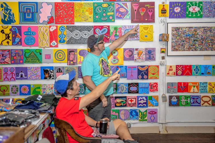 Pop-art style painter Luke Cavagnac, standing, is seen in his “Invisible Fountain” studio in Eastworks in 2022 during the Open Studios weekend.