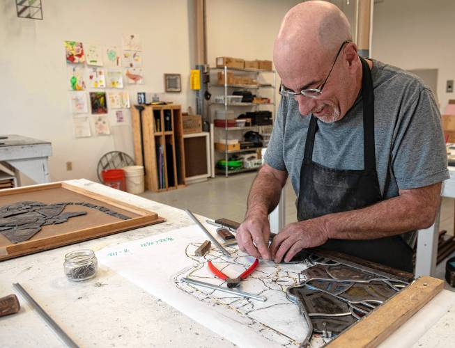  Glenn Shalan, owner of Shalan Stained Glass in Easthampton, works in his studio, where he is restoring windows from Riverside Church in New York City.