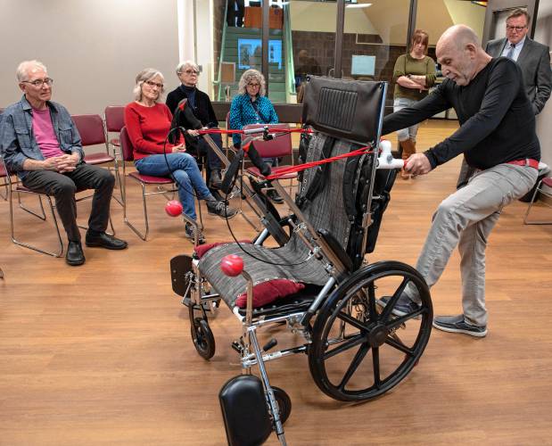Marvin Glover demonstrates Realchair, a proof-of-concept prototype patented in May 2022, during last week’s second annual Amherst Senior Center Health Fair at the Bangs Community Center.