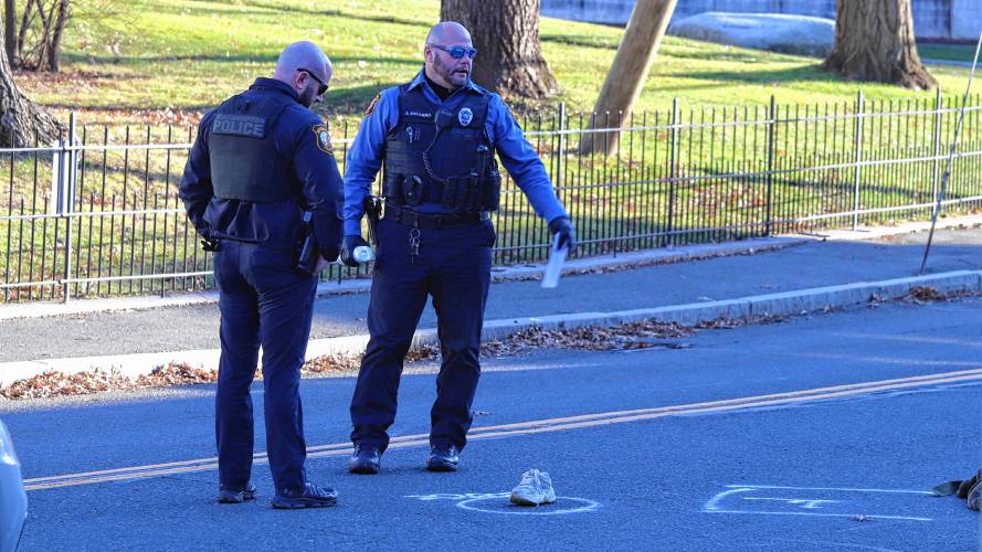 Two police officers stand along West Street in Northampton following a vehicle crash on Dec. 14 that caused serious injuries to a Smith College student. 