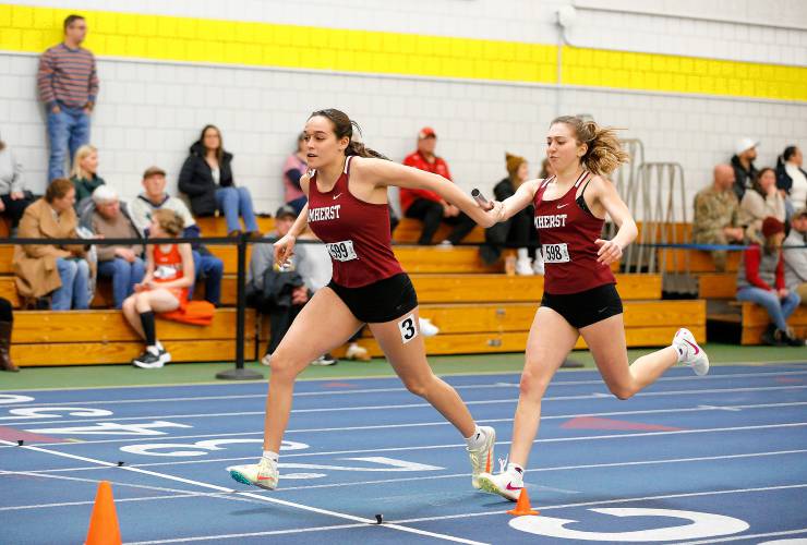 Amherst’s Ella Austin, right, hands off the baton to sister Ruby Austin while running to a first place finish in the girls 4x200 meter relay along with teammates Ololara Baptiste and Kora Brissett during the PVIAC indoor track meet Wednesday at Smith College in Northampton.