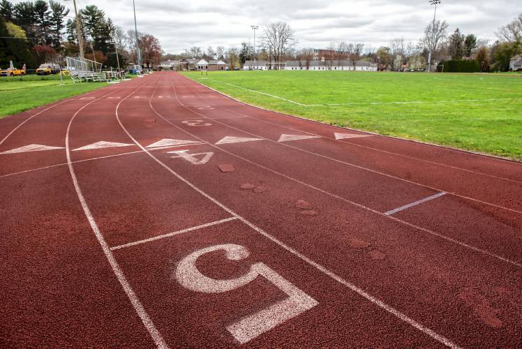 The Amherst Regional High School varsity athletic field and six-lane track, with some repair patches visible in lane four. Photographed on Tuesday, May 3, 2022.
