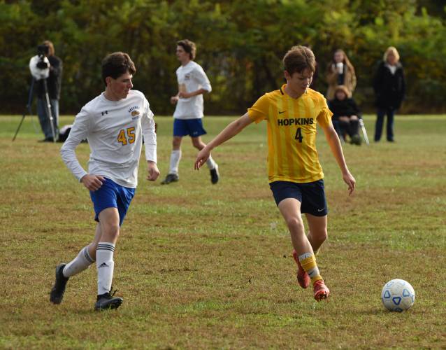 Hopkins Academy’s Chace Earle (4), right, looks to make a pass while defended by Gateway’s Bow Briggs (45) during the teams’ 2-2 draw on Monday in Hadley.