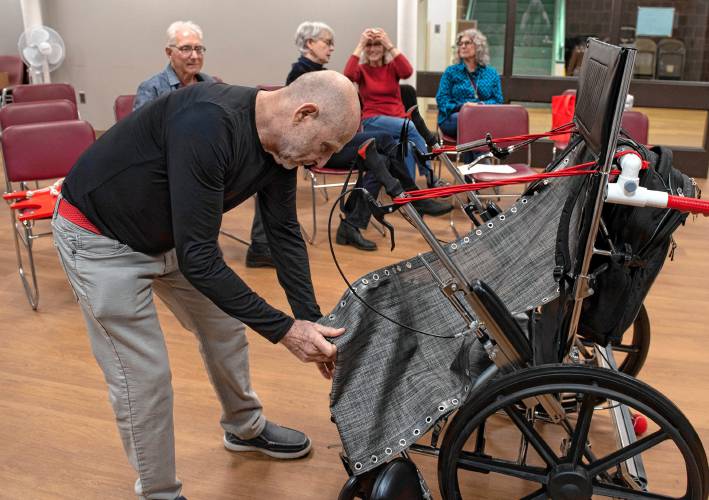 Marvin Glover demonstrates the prototype of the Realchair, a wheelchair he invented that allows for more user independence and comfort, at the second annual Amherst Senior Center Health Fair last week.  The mesh is a breathable material that works as a hammock allowing the person in the chair to have less stress on their body when sitting or in reclined position.