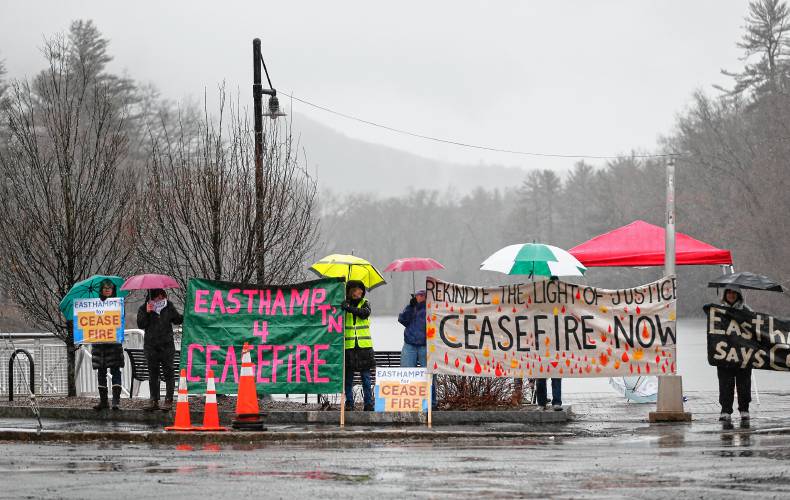 Around a dozen people gathered in the freezing rain Wednesday afternoon at the Nashawannuck Pond Boardwalk for a cease-fire standout just before the Easthampton City Council adopted a resolution calling for a cease-fire in Gaza as the war approaches the six-month mark. 