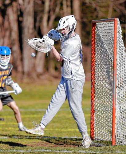 Northampton goalie Henry Fallon (19) makes a save against Chicopee Comp in the second quarter Tuesday in Northampton.