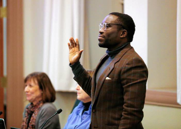 District 1 Councilor Ndifreke Ette is sworn in to the Amherst Town Council on Tuesday night at the Amherst Town Hall. 