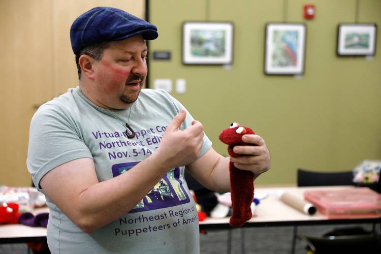 Eric Weiss of Homeslice Puppetry instructs a class on making deluxe sock puppets Thursday night at the South Hadley Public Library. 