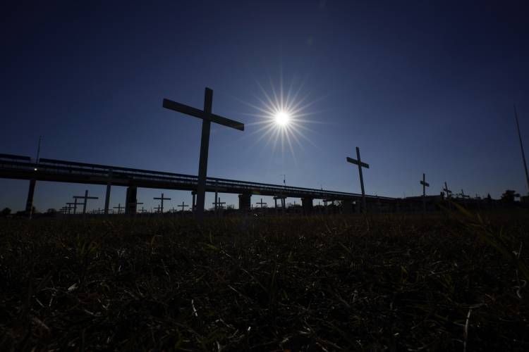 Crosses placed in memorial for migrants who died trying to cross the Rio Grande into the U.S. from Mexico stand near an international bridge on Jan. 3 in Eagle Pass, Texas.