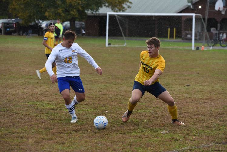 Hopkins Academy’s Nicholas Uchneat (15), right, and Gateway’s David Nedeoglo (42) battle for possession during the teams’ 2-2 draw on Monday in Hadley.