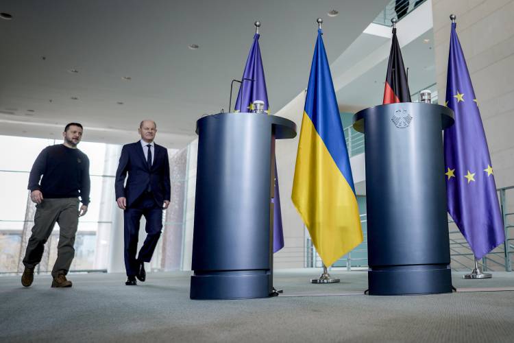 German Chancellor Olaf Scholz, right, and Ukrainian President Volodymyr Zelenskyy walk to a press conference in the chancellory in Berlin on Friday.