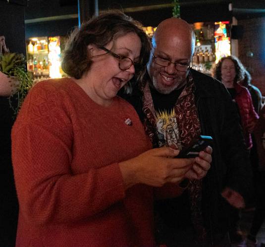 Northampton city councilors Marissa Elkins and Garrick Perry look over the numbers as they come in at a post-election party Tuesday after the polls closed at Mexcalito. Elkins retained her at-large position on the council and Perry, the current Ward 4 councilor, won an at-large spot. 