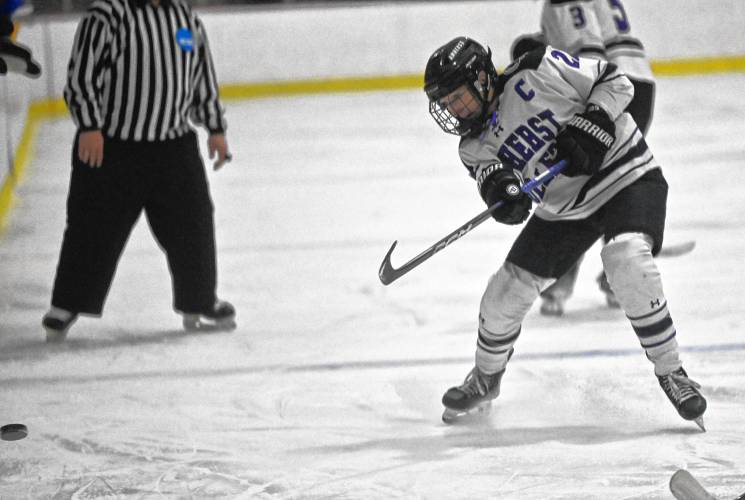 Amherst College captain Rylee Glennon dumps the puck into the attacking zone during the Mammoths’ 4-2 win over Western New England on Tuesday night at Orr Rink.