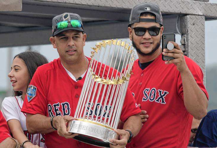 Red Sox manager Alex Cora, left, and pitcher Eduardo Rodriguez arrive at Cora's hometown with the 2018 World Series trophy, accompanied by Chairman Tom Werner and President and CEO Sam Kennedy, as well as seven Red Sox players and coaches, in Caguas, Puerto Rico on November 3, 2018.