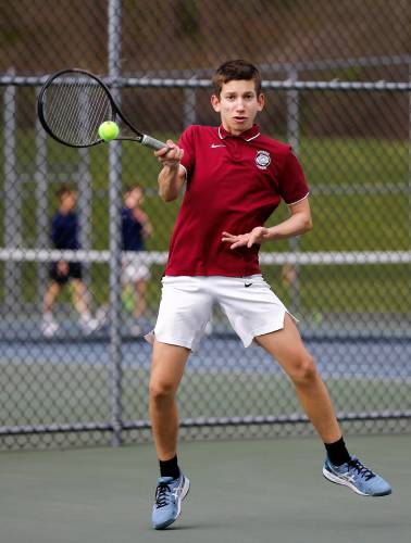 Amherst’s Elias Katsaros volleys against Northampton’s Durrell Patrick during their No. 2 singles match Wednesday in Amherst.