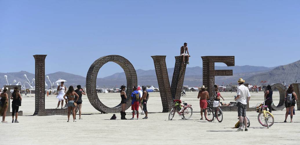 Participants walk around at the Burning Man festival on the Black Rock Desert of Gerlach, Nev., on Aug. 27, 2014. Burning Man organizers don’t foresee major changes in 2024 thanks to a hard-won passing grade for cleaning up this year’s festival.