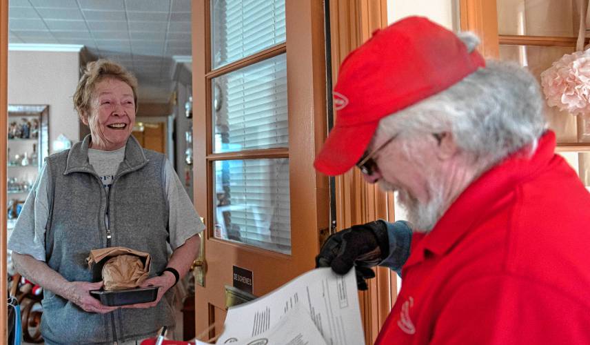 Dunderdale drops a meal off to Mary Deschenes at her home in Holyoke on Monday, where the two chat about her latest eye surgery. “It’s nice to see a friendly face,” she says.